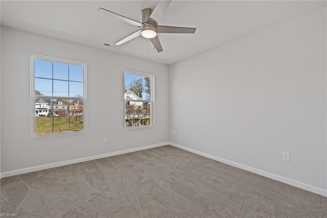 carpeted empty room featuring ceiling fan