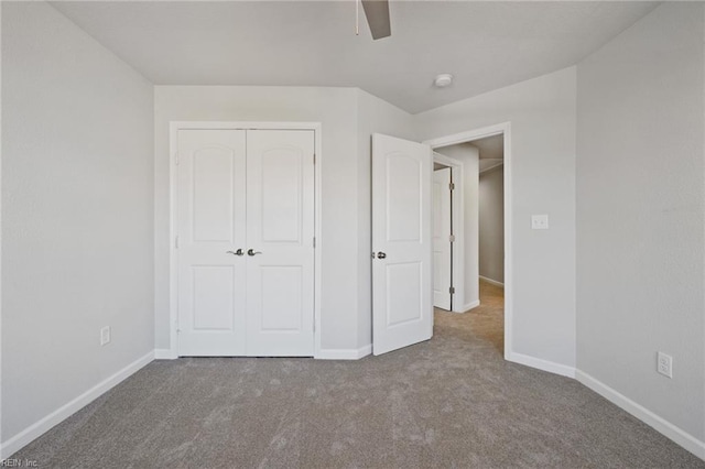 unfurnished bedroom with carpet flooring, a closet, and ceiling fan