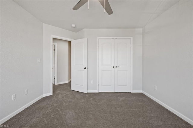 unfurnished bedroom with ceiling fan, a closet, and dark colored carpet