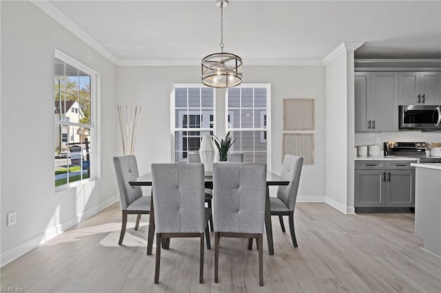 dining area with plenty of natural light, light wood-type flooring, ornamental molding, and a chandelier