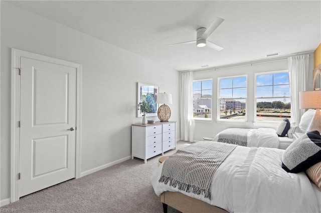 bedroom with ceiling fan and light colored carpet