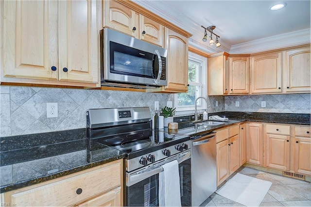 kitchen featuring sink, light brown cabinets, decorative backsplash, appliances with stainless steel finishes, and ornamental molding