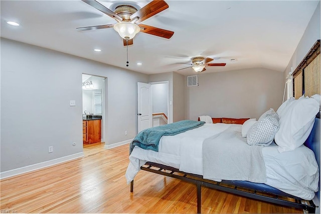 bedroom featuring light hardwood / wood-style floors, vaulted ceiling, and ceiling fan