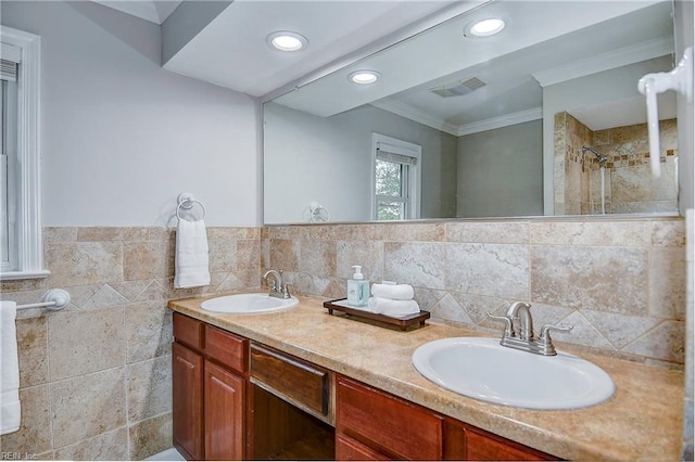 bathroom featuring crown molding, vanity, and tile walls