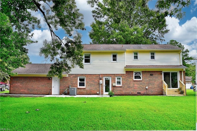 rear view of house featuring a lawn and central AC