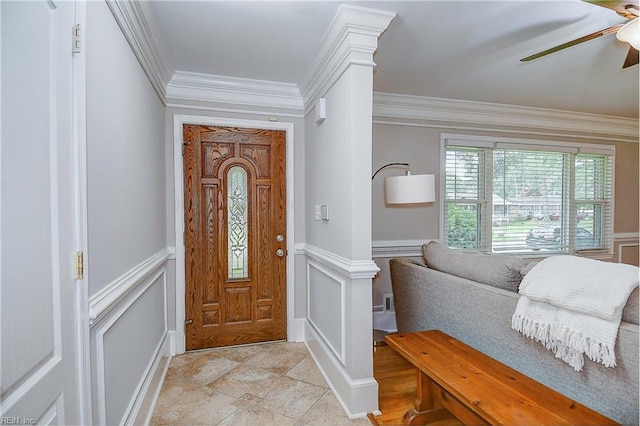 foyer entrance featuring ceiling fan and ornamental molding