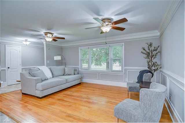 living room featuring light hardwood / wood-style flooring, ceiling fan, and ornamental molding