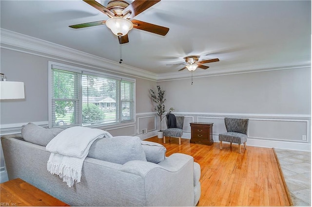 living room with ceiling fan and ornamental molding