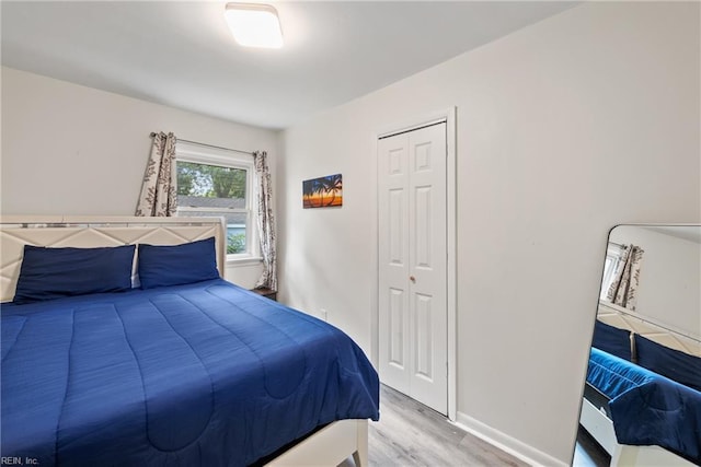 bedroom with a closet and light hardwood / wood-style flooring