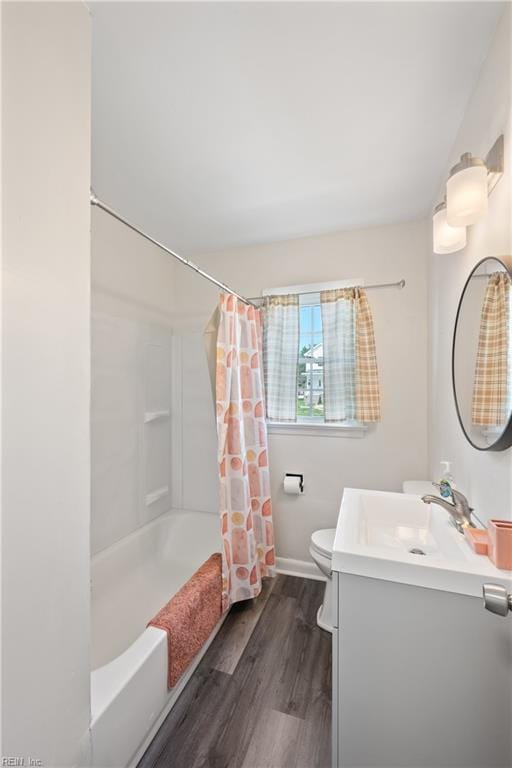 full bathroom featuring shower / tub combo, vanity, wood-type flooring, and toilet