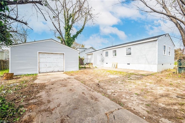 exterior space featuring a garage and an outbuilding