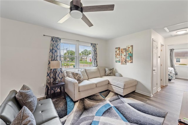 living room featuring light hardwood / wood-style floors and ceiling fan