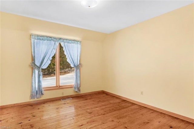 empty room with hardwood / wood-style flooring