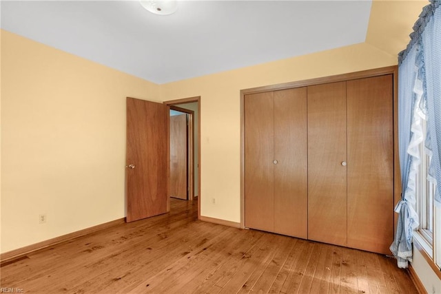 unfurnished bedroom with light hardwood / wood-style floors and a closet