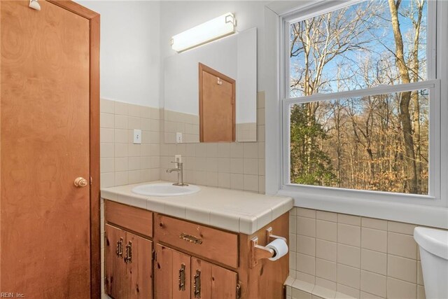 bathroom featuring toilet and vanity