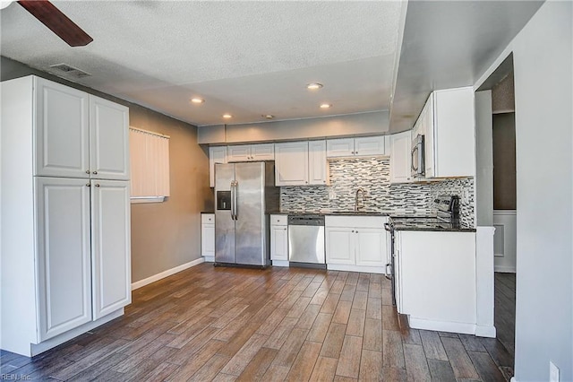 kitchen featuring white cabinetry, dark hardwood / wood-style floors, and appliances with stainless steel finishes