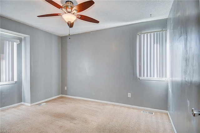 spare room with light carpet and ceiling fan