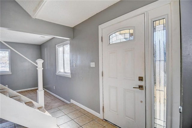 foyer featuring a healthy amount of sunlight and light tile patterned flooring