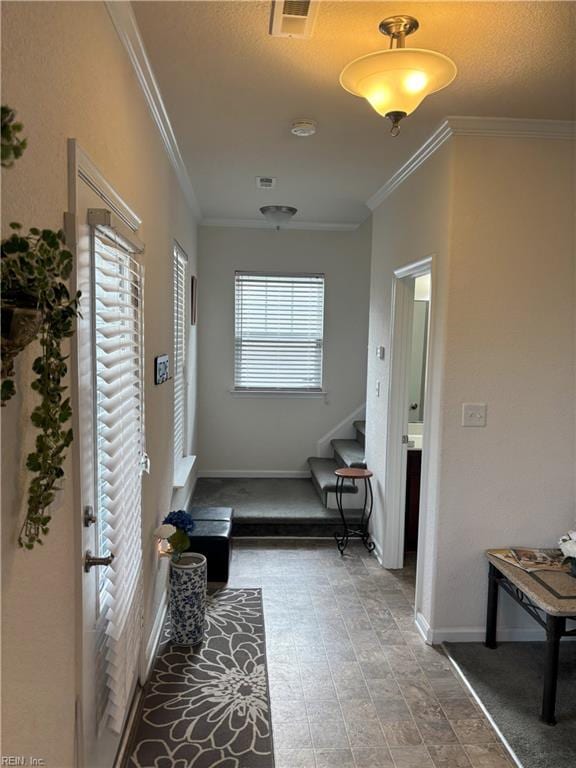 corridor featuring a healthy amount of sunlight and ornamental molding