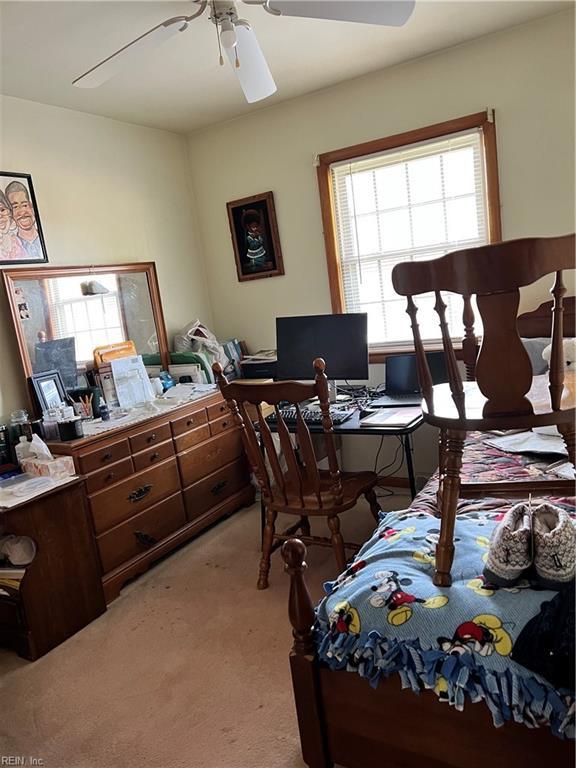 bedroom with light colored carpet and ceiling fan