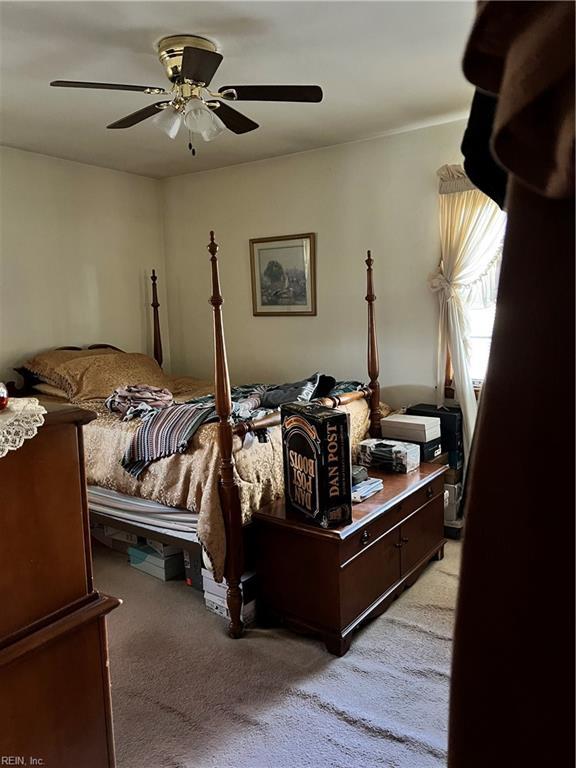 bedroom with ceiling fan and light colored carpet