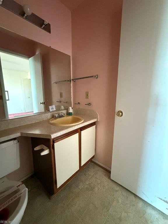 bathroom featuring vanity and toilet