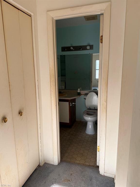 bathroom with vanity and toilet