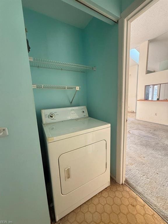 laundry room with washer / dryer and light colored carpet