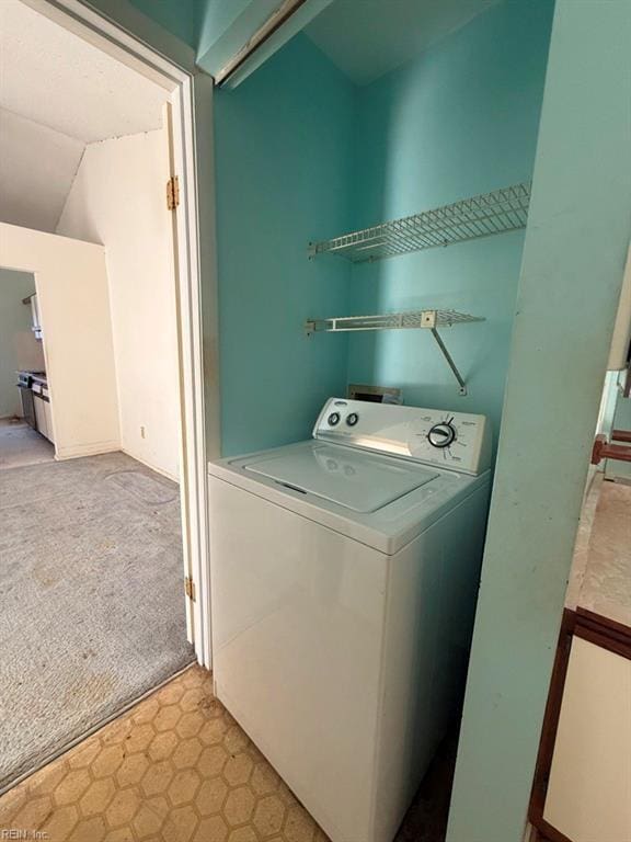 laundry room with washer / dryer and light colored carpet