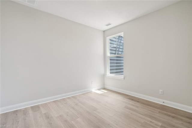 unfurnished room featuring a wealth of natural light and light wood-type flooring