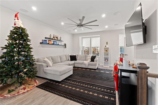 living room with hardwood / wood-style flooring and ceiling fan