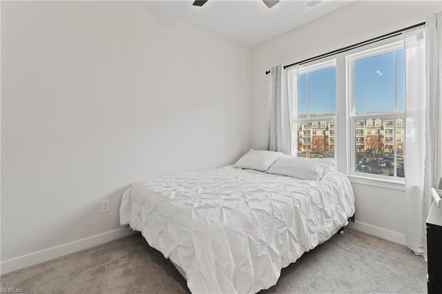 bedroom featuring multiple windows, carpet floors, and ceiling fan