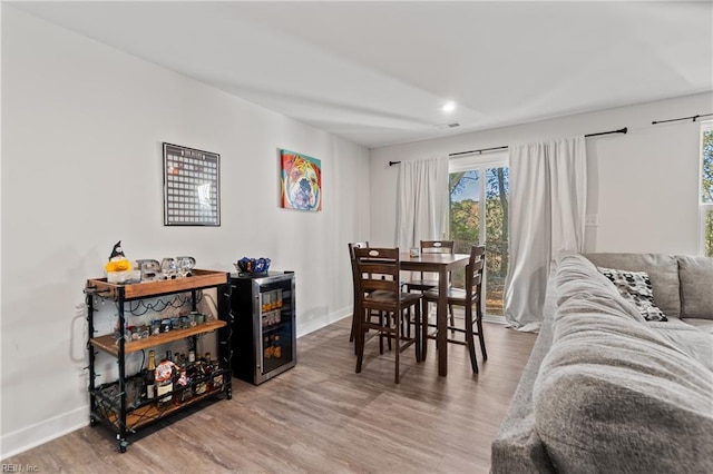 dining room featuring wood-type flooring and wine cooler