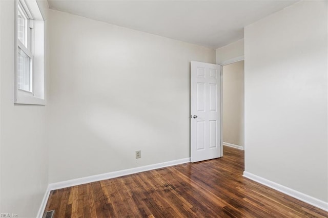 unfurnished room featuring dark hardwood / wood-style floors