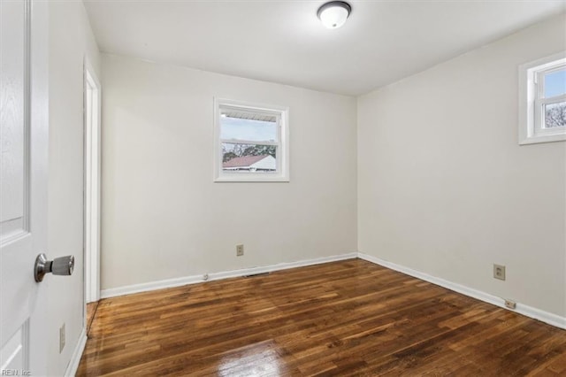 unfurnished room featuring dark wood-type flooring