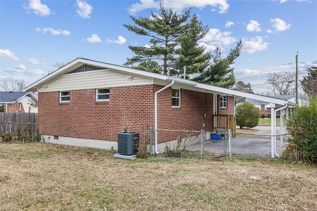 view of home's exterior featuring a yard and central AC