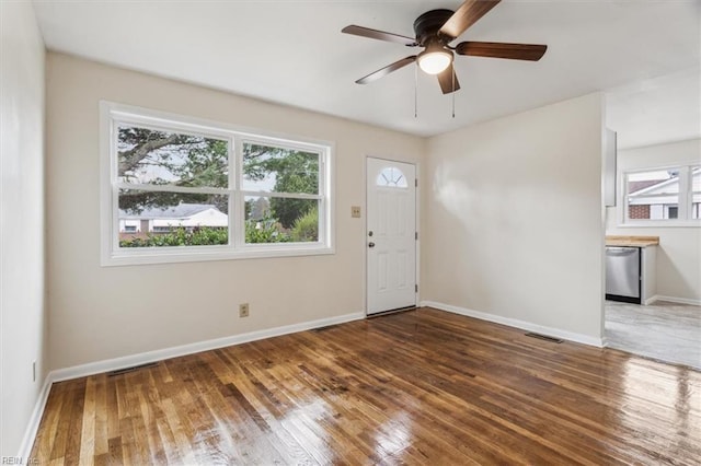 entrance foyer featuring dark hardwood / wood-style flooring, a wealth of natural light, and ceiling fan