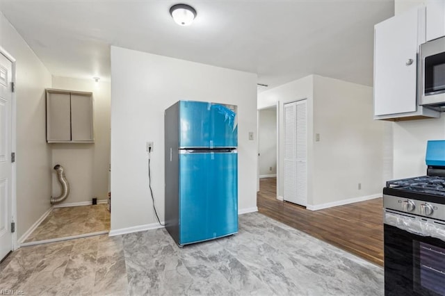 kitchen featuring white cabinets and stainless steel appliances