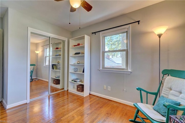 sitting room featuring ceiling fan and light hardwood / wood-style flooring