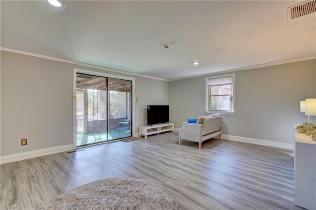 unfurnished room featuring light hardwood / wood-style floors and crown molding