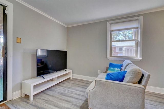 living area featuring light hardwood / wood-style floors and crown molding