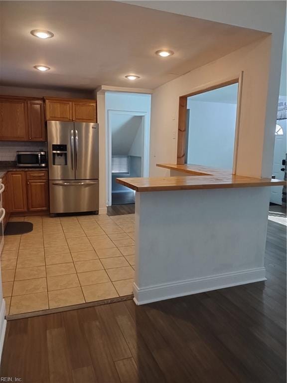 kitchen with light tile patterned floors and appliances with stainless steel finishes