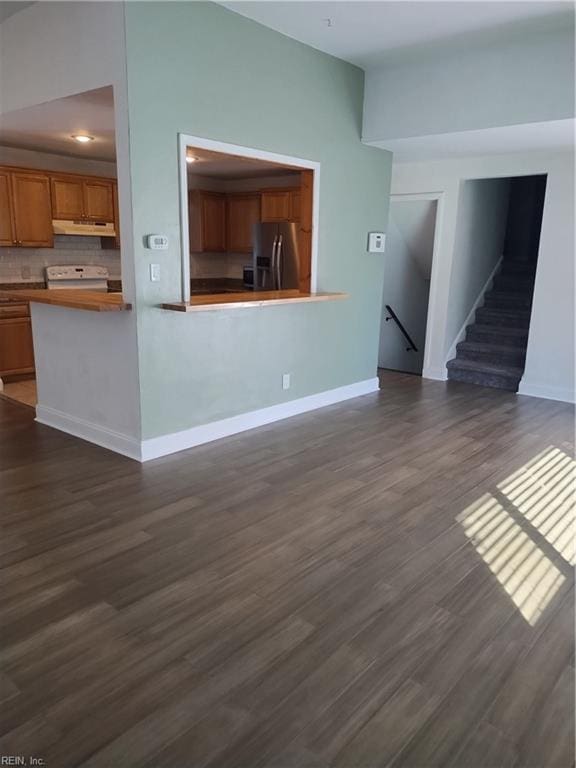 unfurnished living room featuring dark hardwood / wood-style flooring