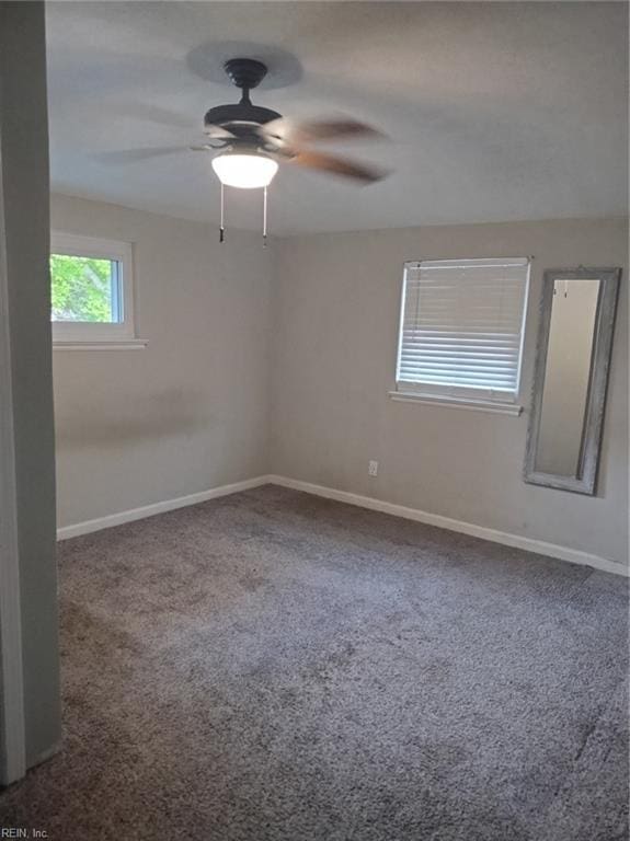 carpeted spare room with ceiling fan