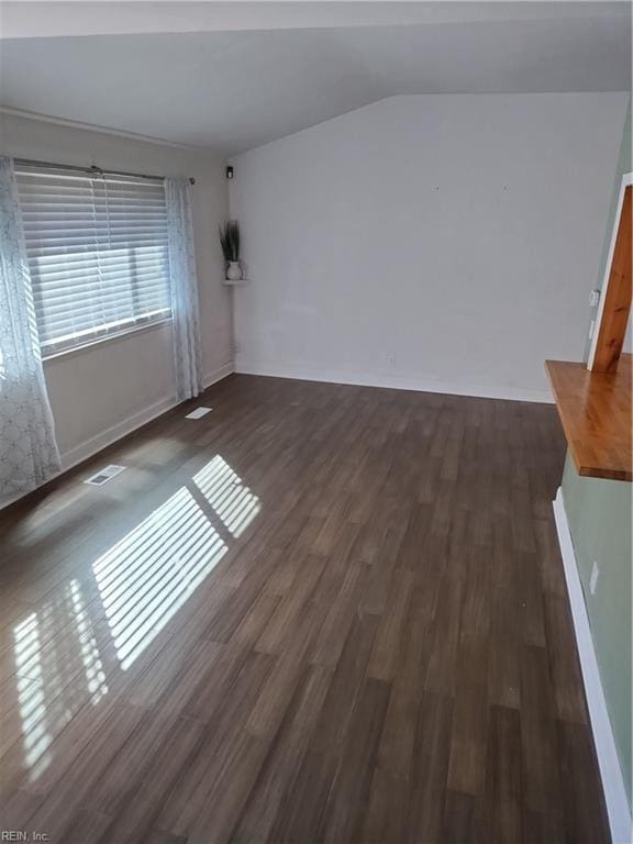 interior space featuring dark hardwood / wood-style floors and lofted ceiling