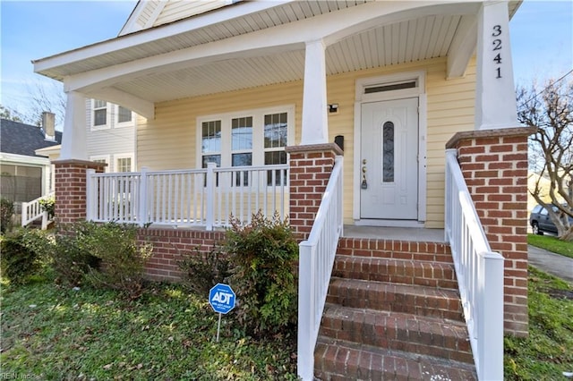 doorway to property featuring covered porch