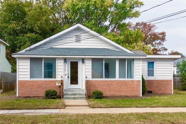 bungalow-style house with a front lawn