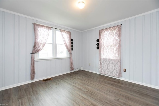 unfurnished room with dark hardwood / wood-style floors and ornamental molding