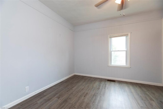 unfurnished room with ceiling fan and dark hardwood / wood-style floors