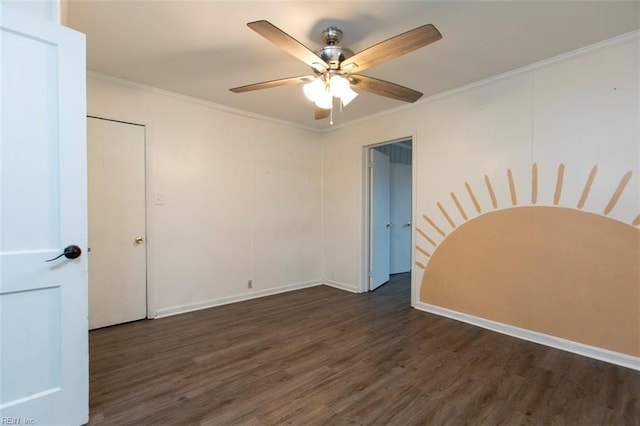 spare room featuring dark wood-type flooring, ceiling fan, and crown molding